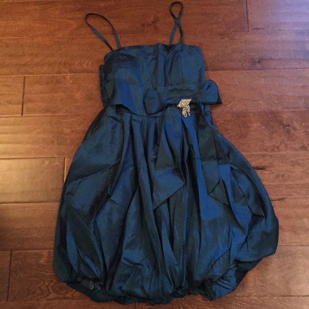 Flattering Teal Dress with crystal brooch
